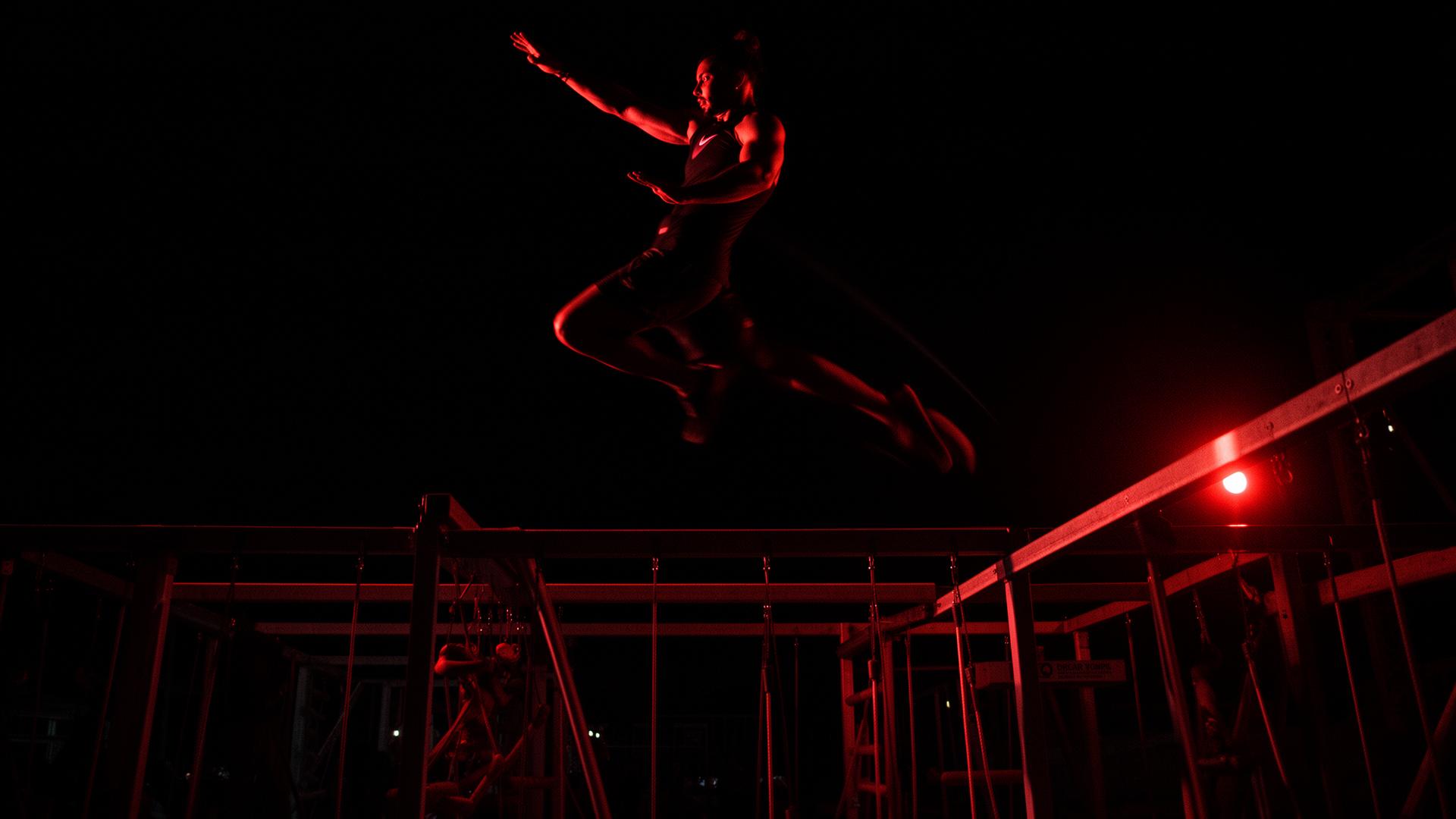 Ninja athlete launching across an obstacle